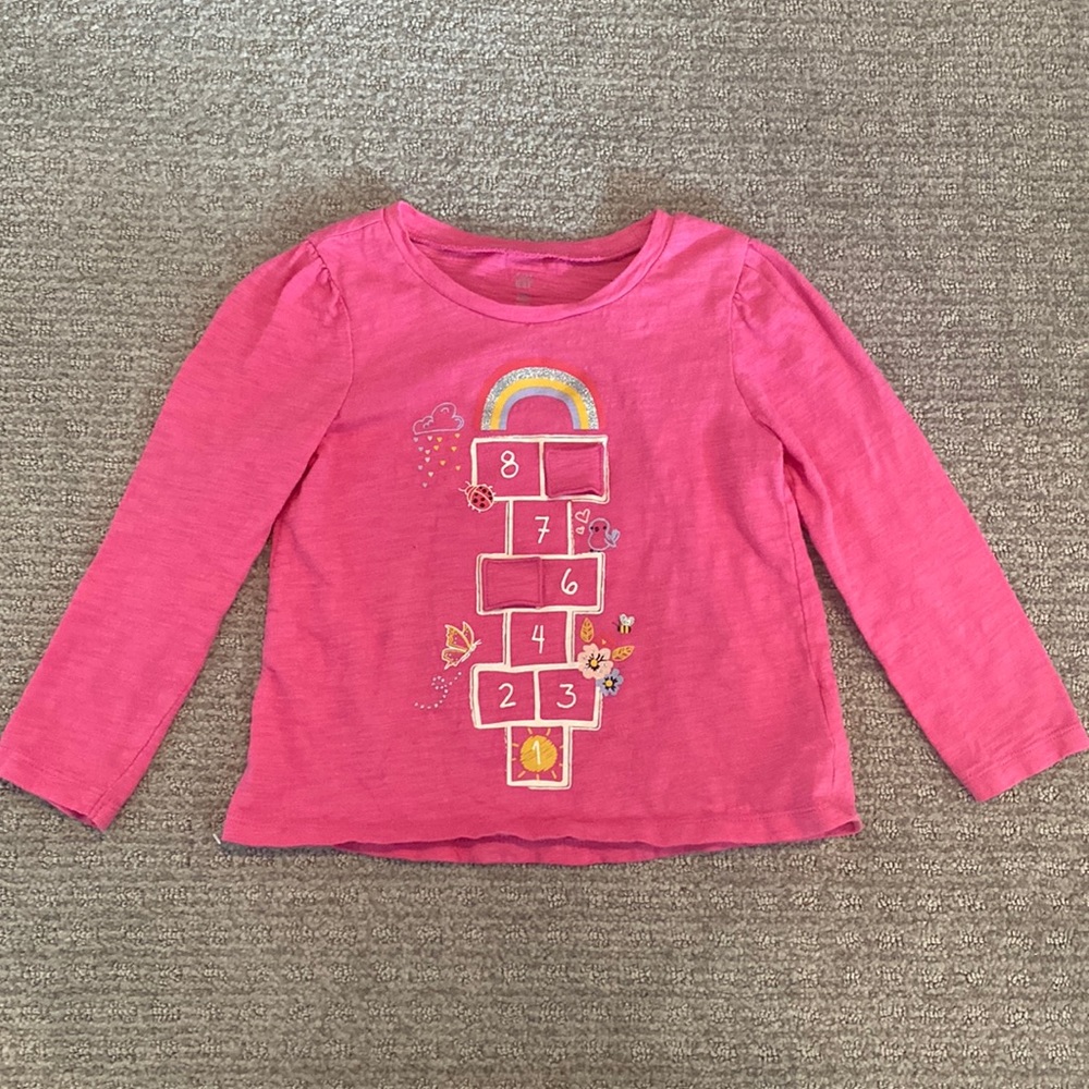 Hopscotch shirt with two peekaboo flaps